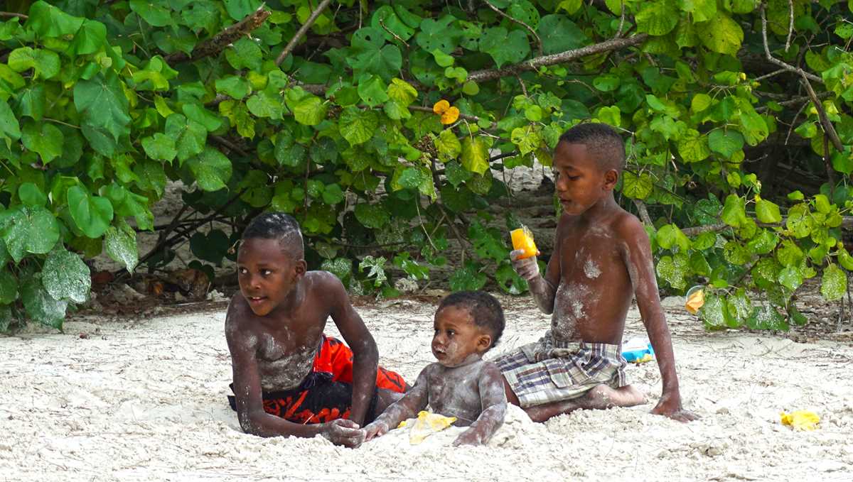 Local Creole kids playing on the beach in Seychelles